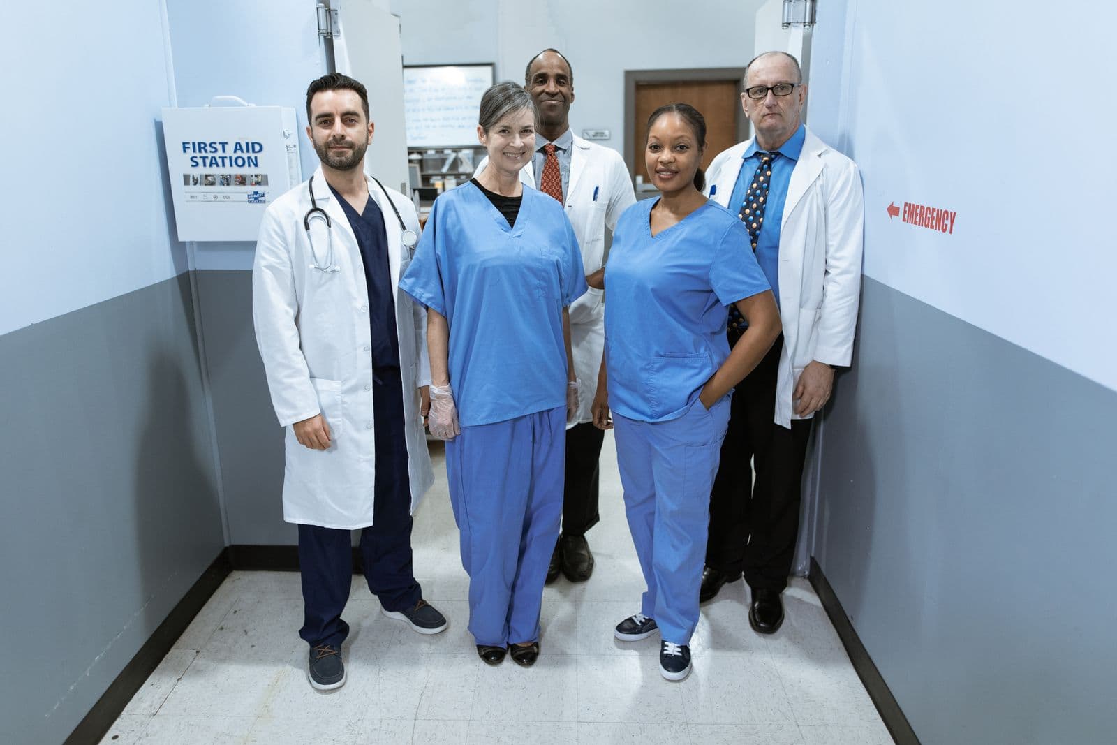 Healthcare staff in scrubs working together in a clinical environment